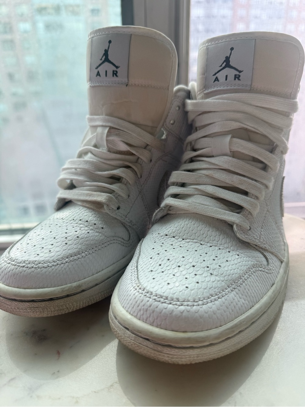 Nike White High-Top Jordan Sneakers with Black Logo